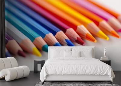  A line of colored pencils alignment on a white tabletop, one pencil centered in the middle Wall mural