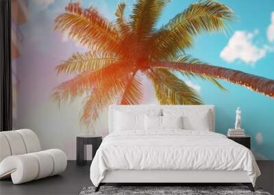  A palm tree stands before a building, sun illuminating clouds behind Wall mural