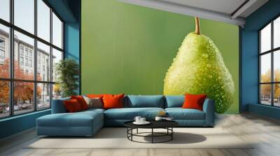  A pear atop a table, dripping with water, against a green backdrop Wall mural