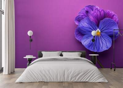  A purple flower with a yellow center against a purple backdrop, featuring a yellow center at its heart Wall mural