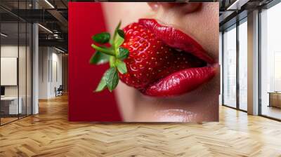  A tight shot of a woman's parted lips, holding a protruding strawberry and a dangling green leaf Wall mural