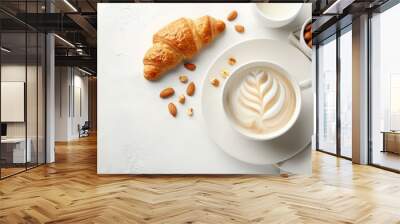  A white plate holds a steaming cup of coffee, a croissant nearby, and a bowl of almonds Wall mural