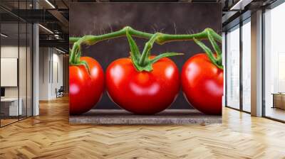  Five red tomatoes sit atop a weathered wooden table A solitary green stem lies nearby against a backdrop of black Wall mural