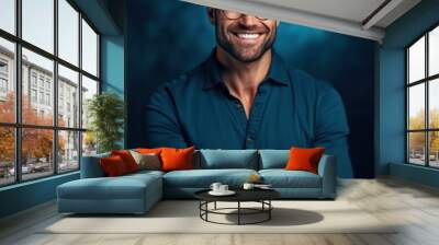 A bearded man wearing glasses smiles warmly at the camera Wall mural