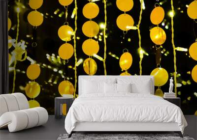 Golden balls in garlands decorate the interior. Festive attire in celebration of the New Year and Christmas. Gold and black abstract background Wall mural