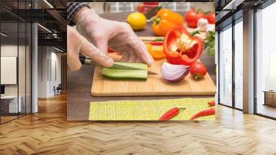 Chef cutting cucumber and vegetables for salad close up. Hands in gloves cooking healthy vegetarian vegan diet food Wall mural