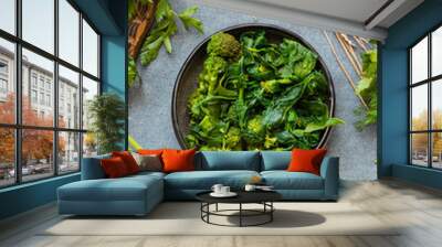 green cooked sauteed broccoli, spinach salad meal. woman eat broccoli. vegan healthy diet food. Wall mural