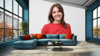 Portrait of young beautiful gcaucasian woman in red t-shirt cheerfuly smiling looking at camera. Studio photo isolated on white background. Copy space. Wall mural