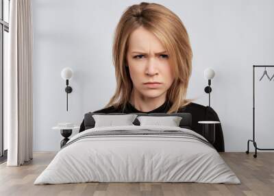 portrait of young serious angry woman with blond hair Wall mural