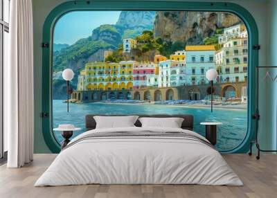 Panoramic view of Amalfi Coast Italy from ferry boat deck. Colorful buildings with yellow red and blue roofs stand out against deep blue sea. Perfect for travel agency tours and vacation inspiration. Wall mural