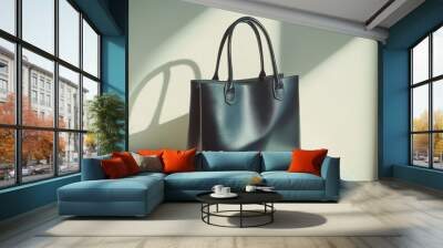 Elegant black leather tote bag with sleek handles and soft shadows. Wall mural