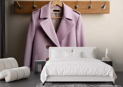 Elegant lavender coat hanging on a wooden rack, showcasing its stylish design and soft fabric. Wall mural