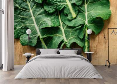 Fresh Collard on wooden background  Wall mural