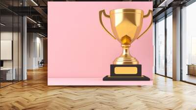 Winner, Golden Cup. A shiny golden trophy sits on a black base in front of a light pink background Wall mural