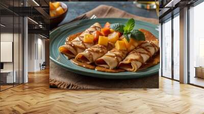 Delightful mango crepes with caramel drizzle and fresh mint garnish Wall mural