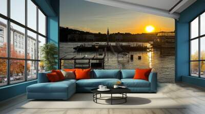 Sunset scene over Danube river with partially submerged structures due to flooding.  Wall mural