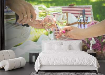 Two glasses of white wine with picnic basket.  Wall mural