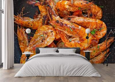 Grilled large shrimps (tiger) cooked in a frying pan with spices, herbs and lemon on a dark background. Wall mural