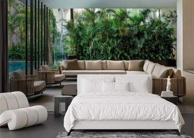 Relax in the spacious outdoor area featuring comfortable sofas and a wooden coffee table, surrounded by lush greenery and a serene swimming pool backdrop Wall mural