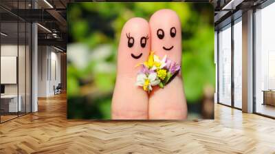 Finger art of a Happy couple. Man is giving flowers to a woman.  Wall mural