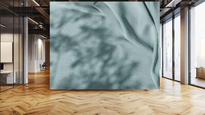 Pastel sage green blue cloth texture with folds and abstract soft floral sunlight shadows, aesthetic neutral background with copy space for wedding design or business branding Wall mural