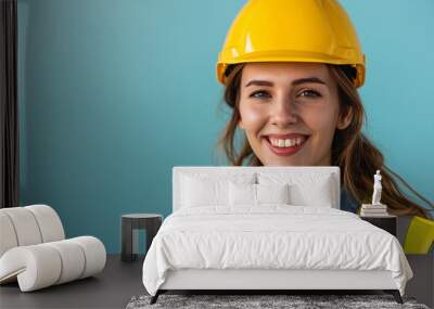 Portrait of smiling female engineer with yellow safety helmet and vest on plain blue background. Generative AI Wall mural