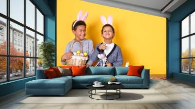 two boys in bunny ears studio isolated on yellow wall easter celebration concept sitting holding bas Wall mural