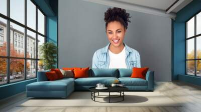 Young african woman isolated on grey wall studio casual daily lifestyle smiling Wall mural