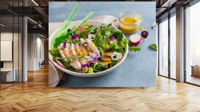 spring salad with radishes, chicken breast and edible flower Wall mural