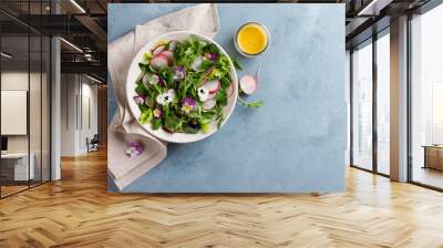 Spring salad with radishes, edible flower and sauce Wall mural