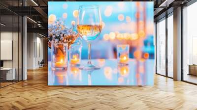 Elegant Evening: Wine Glass, Candles, and Flowers on Reflective Surface Wall mural