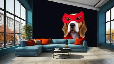 A cute beagle dog in a superhero costume: in a red mask and cape for a carnival party or Halloween on a black isolated background. Copy space Wall mural