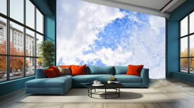 Cloudy fluffy blue bright sky closeup  Wall mural