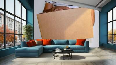 Man is holding cardboard box delivery parcel. Online shopping and Express delivery. Delivery man. Wall mural