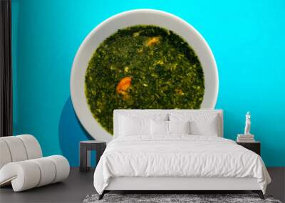 Molokhia soup with shrimps on blue background. Flat lay, top view. Moroheiya, Mulukhiya Wall mural