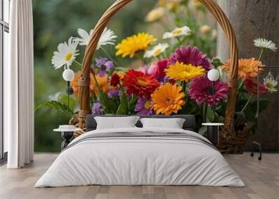 beautiful bouquet of bright flowers in basket on wooden table Wall mural