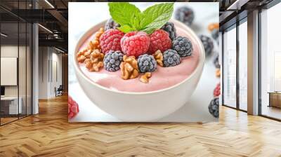 Delicious smoothie bowl topped with fresh raspberries, blackberries, walnuts, and mint leaves, perfect for a healthy breakfast. Wall mural