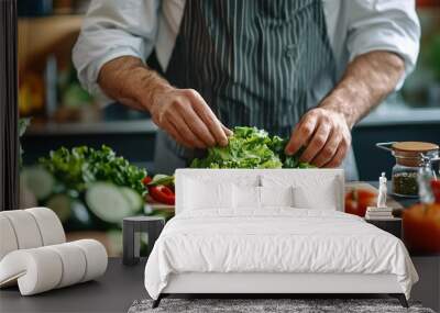 Professional chef preparing a fresh salad on the kitchen counter, with various ingredients like bell peppers, lettuce, and cucumbers around him Wall mural