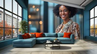 A mature businesswoman standing near a window, holding a digital tablet and smiling confidently in a corporate office Wall mural