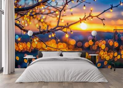 Evening bokeh of orange light with a tree branch in the foreground aerial view Wall mural