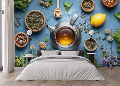 A kettle surrounded by herbal tea ingredients like mint, lemon, and honey. Wall mural