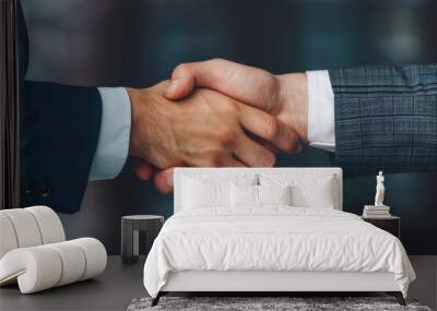 Close-up of a professional handshake between two individuals in suits, symbolizing agreement, partnership, and business collaboration. Wall mural