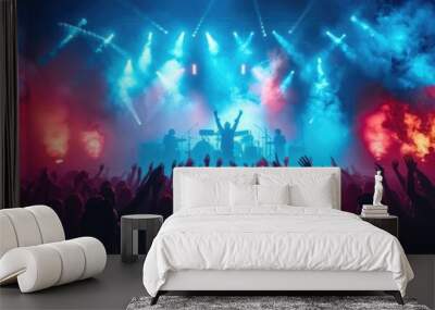 Energetic concert crowd with raised hands enjoying live music under vibrant blue and red stage lights in a packed venue. Wall mural