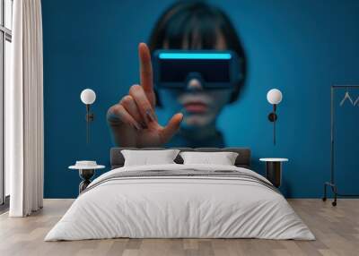 woman wearing a virtual reality headset, reaching out to interact with a virtual interface. The image highlights advanced VR technology and immersive experiences. Wall mural