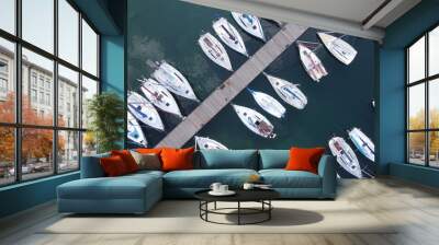 Boats floating on lake water in small harbor pier Wall mural