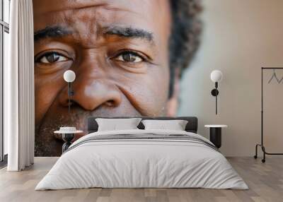 middle-aged black man with curly hair and a thoughtful expression. His skin is dark, and he has a slight beard. The background is softly blurred, emphasizing his face and eyes. Wall mural