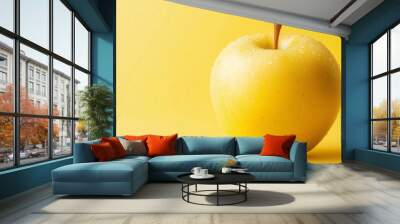 yellow apple with water drops on a yellow background, sweet and tasty fruit Wall mural