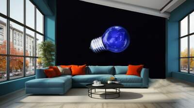 electric blue light bulb on black background Wall mural