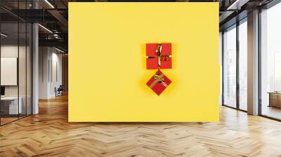 two red gift boxes on yellow background. Wall mural