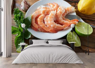 Shrimps on a plate with lime and herbs on wooden background Wall mural